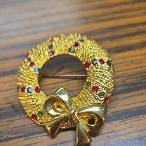 Elegant Gold Wreath Brooch with Red and Green Accents